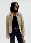 Aviator jacket Faux fur material  Large collar  Bucket fastening at neckline Zip front fastening  Twin hip pockets  Buckles at hem 