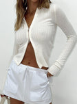 Long sleeve white top Soft ribbed material  Classic collar  Double zip front fastening 