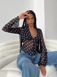 long sleeve black top Sheer material Polka dot print V-neckline Button fastening at front Waist tie fastening at back