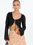 Long sleeve top Sheer material Frill neckline and hem Tie fastening at bust Flared sleeves