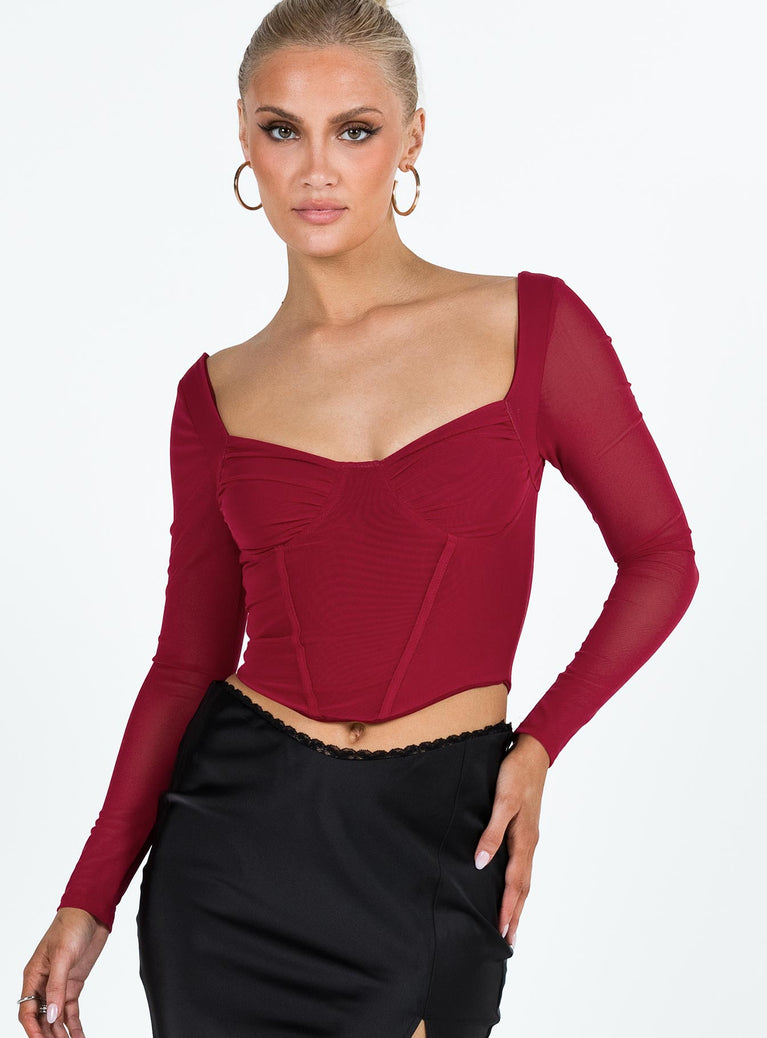 Long sleeve top Sheer mesh material Sweetheart neckline Slight ruching at bust Curved hem Good stretch Lined body