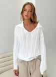 White sweater Cable knit material Wide neckline Classic collar Good stretch Unlined 