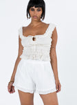 White shorts Textured material Invisible zip fastening at side Subtle pleats at front Ruffle hem