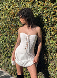 White strapless mini dress Inner silicone strip at bust lace up detail at front Invisible zip fastening at back Boning through waist Lace detail at skirt