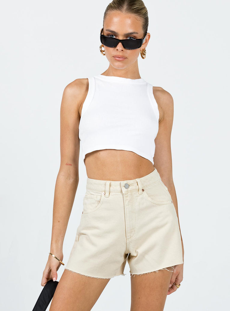 Denim shorts High waisted  Zip & button fastening  Classic five-pocket design  Belt looped waist  Ripped legs  Raw edge hem 