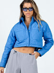 Cropped blue puffer jacket Quilted material Classic collar Press button fastening at front Twin chest pockets