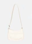 Cream crossbody bag Faux leather material Adjustable crossbody strap Gold-toned hardware Zip fastening Slip at back Flat base