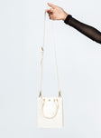 Beige bag Faux leather material  Croc print  Twin handles  Removable & adjustable shoulder strap  Internal card slip  Magnetic b