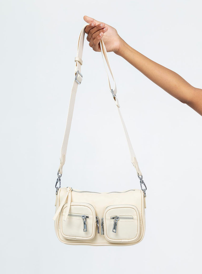 Crossbody bag Nylon material Silver toned hardware Two external pockets Zip closures Adjustable & removable crossbody strap Two internal pockets Flat base