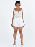 White shorts Textured material Invisible zip fastening at side Subtle pleats at front Ruffle hem