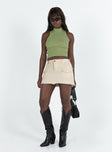 Cargo mini skirt Mid rise Belt looped waist Zip and button fastening Six pocket design Raw edge hem