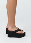 Sandals Flip-flop style upper  Exaggerated platform base  Rounded toe