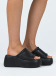 Flatforms Single faux leather upper Padded footbed Open square toe Chunky slip-on style Lightweight