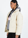 Puffer jacket High neck Zip front fastening Twin zip front pockets Ribbed cuffs