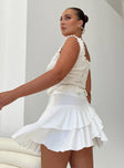 White mini skirt Wrap look Tiered skirt Good stretch Unlined