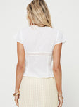 Top V-neckline, knit lace trim, tie detail at bust, button fastening at front