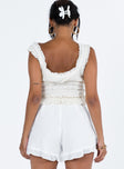 White shorts Textured material Invisible zip fastening at side Subtle pleats at front Ruffle hem