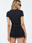 Micro mini skirt Black denim Low rise Belt looped waist Zip & button fastening Classic five pocket design Raw edge hem