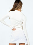 Long sleeve white top Soft ribbed material Classic collar Double zip front fastening