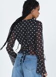 long sleeve black top Sheer material Polka dot print V-neckline Button fastening at front Waist tie fastening at back