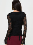 Black Long sleeve top Lace material, v neckline, tie fasting at front, frill detail throughout