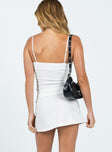 Mini skirt Mid-rise Invisible zip fastening at side Buckle detail Slit at side Non-stretch