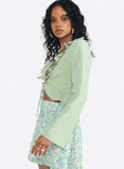 Long sleeve top Frill neckline & hem  Plunging neckline  Tie fastening at front  Flared sleeves 