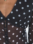 long sleeve black top Sheer material Polka dot print V-neckline Button fastening at front Waist tie fastening at back