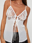 Lace top Adjustable shoulder straps, v-neckline, twin tie fastening at bust, split hem Non-stretch material, unlined, sheer